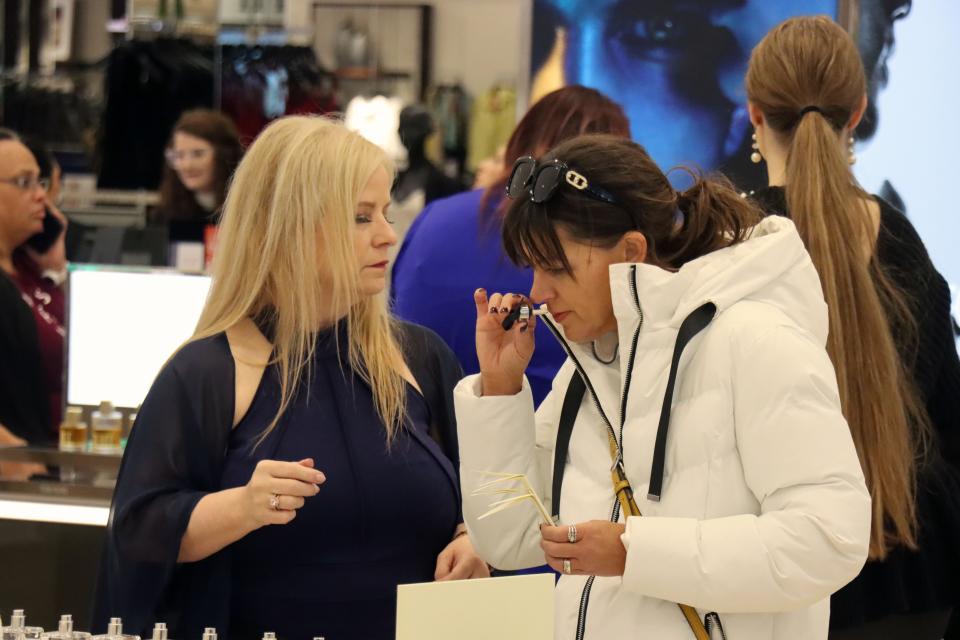 Robin Miller and Torry Moncivais check out perfumes during the grand opening of the Women's Dillard's at Westgate Mall Thursday morning.
