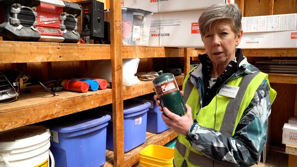Michele Morris of Chittenden Solid Waste District holds up an empty propane fuel canister at CSWD's Williston drop-off center. Fuel canisters cannot go in the trash or the blue recycling bin in Vermont. They can be brought to CSWD drop-off centers.