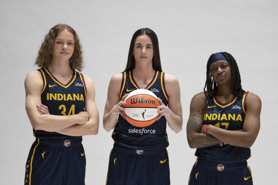 Indiana Fever's Grace Berger, from left, Caitlin Clark and Erica Wheeler pose for a photo during the Indiana Fever media day, Wednesday, May 1, 2024, in Indianapolis. (AP Photo/Darron Cummings)