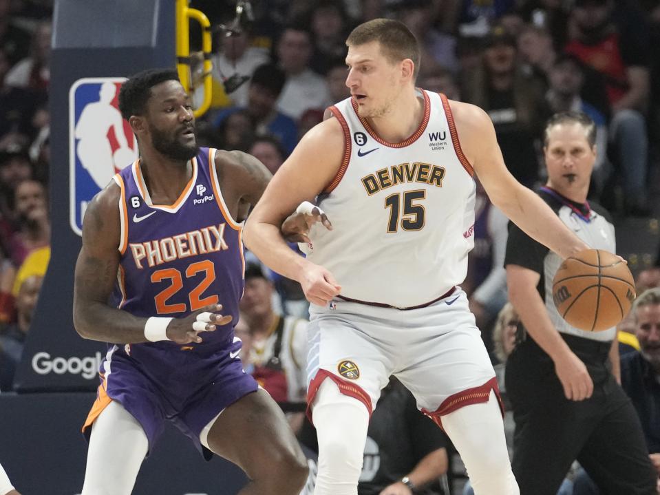 Phoenix Suns center Deandre Ayton (22) defends against Denver Nuggets center Nikola Jokic (15) during the first quarter of the Western Conference semifinals at Ball Arena in Denver on May 9, 2023.