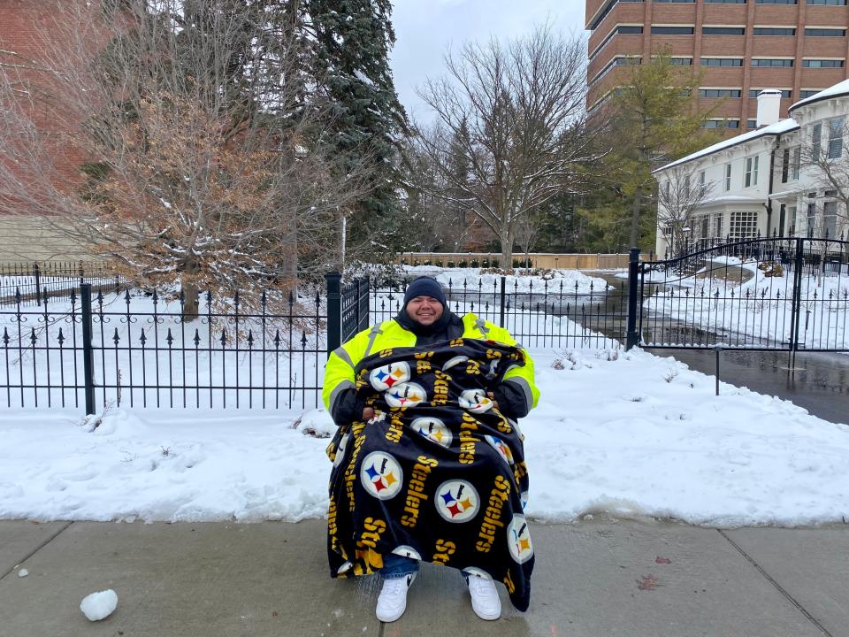 Moises Rodriguez, 31, drove two hours from Ottawa, Ohio, to get a front row seat to the University of Michigan football parade in Ann Arbor on Saturday, Jan. 13, 2024.