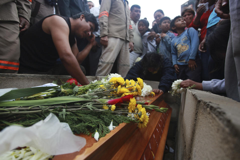 Relatives gather around the coffin that contain the remains of slain journalist Gregorio Jimenez as it is lowered into the ground, at the cemetery in Coatzacoalcos, Mexico, Wednesday, Feb. 12, 2014. Veracruz state officials concluded that Jimenez, a police beat reporter, was killed in a personal vendetta, unrelated to his reporting. But journalists throughout Mexico are calling for a thorough investigation. Jimenez is the 12th journalist slain or gone missing since 2010 in the Gulf state of Veracruz. (AP Photo/Felix Marquez)