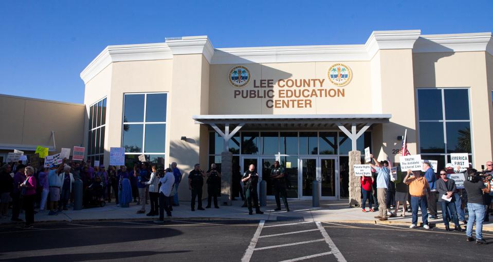 A group of protesters organized by the Lee  OP, right, gathered before the Lee County school board meeting Tuesday, Feb. 6, 2024. They are protesting a flag hung in a Riverdale High School classroom that they say violates The Stop Woke Act because it contains the words Black Lives Matter, and the LGBTQ+ and Trans flags. The Purple Group, left, who say they are non-partisan advocates for public schools, teachers, educators and parents also gathered to show support for the teacher and flag in the school.