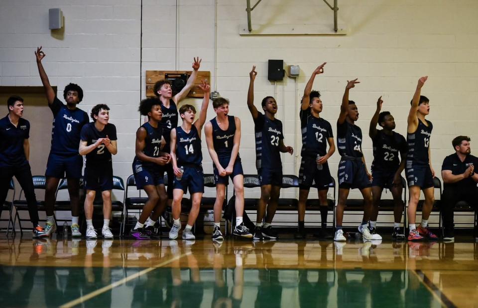 Burlington boys basketball celebrates its D-I quarterfinal victory over St. Johnsbury on Friday, Feb. 23, 2024.