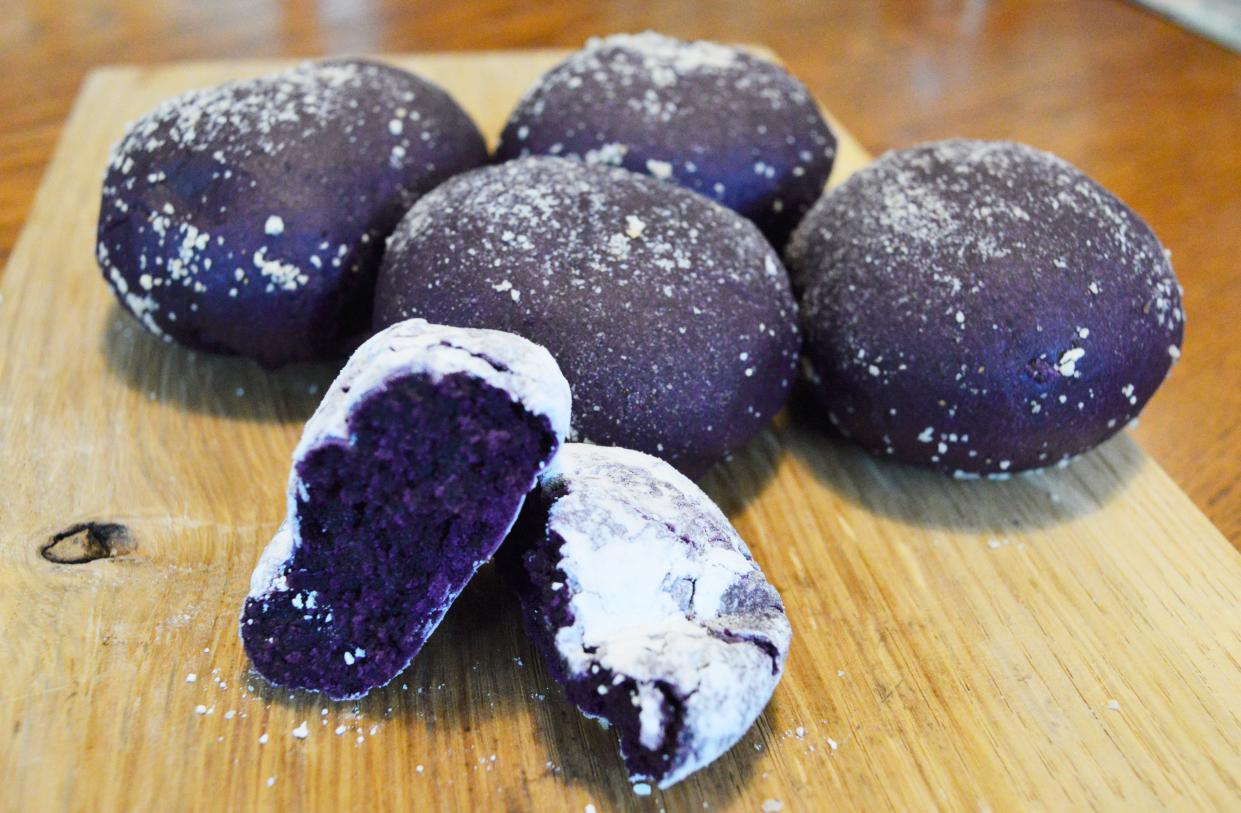 Crinkle cookies, forefront, and pandesal, a Filipino bread roll, are two of the products created by Ube Love.