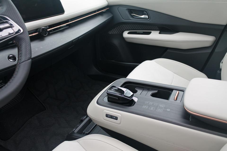 The white and grey center console of the 2023 Nissan Ariya Empower+ SUV.