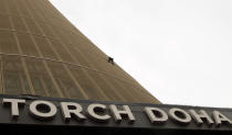 French climber Alain Robert, also known as "Spiderman", scales the tallest building in Doha, the Torch Doha, with a height of 300 metres, in Doha April 12, 2012. REUTERS/Fadi Al-Assaad