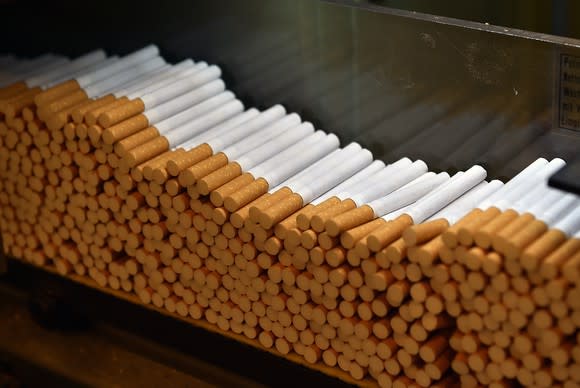 A closeup shot of cigarettes on a manufacturing line.