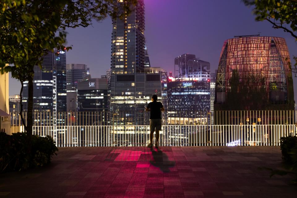 A person looks at buildings in Singapore, Saturday, Feb. 17, 2024. Photographer: SeongJoon Cho/Bloomberg