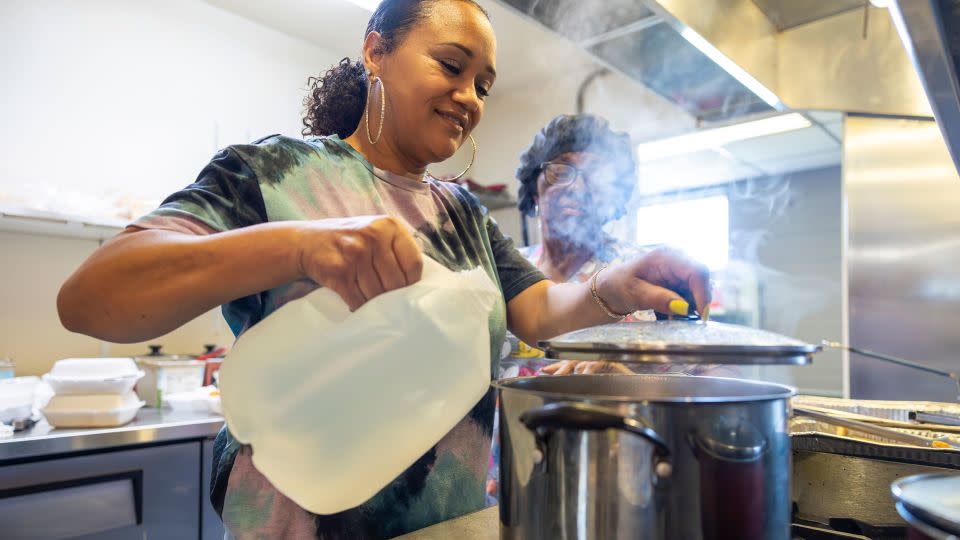 Ashara Feloss uses bottled water for cooking at DJ's One Stop, a lunch place in Plaquemines Parish, in late September. The water in Plaquemines had been salty since early summer before the Army Corps began barging freshwater there in early October. - Chris Granger/The New Orleans Advocate/AP