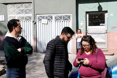 Office workers are seen at a street following an earthquake in Mexico City, Mexico February 1, 2019. REUTERS/Carlos Jasso