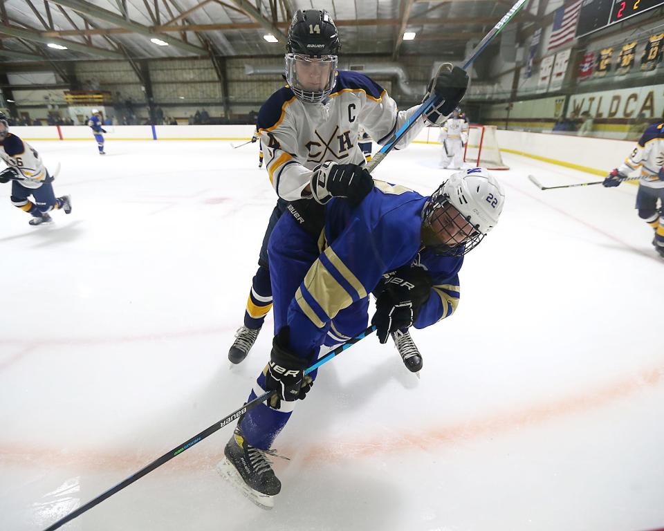 Cohasset/Hull's Luke Richardson battles with Norwell's Austin Shea for the puck along the boards during second period of their game at Connell Rink and Pool in Weymouth on Saturday, Jan. 21, 2023. 