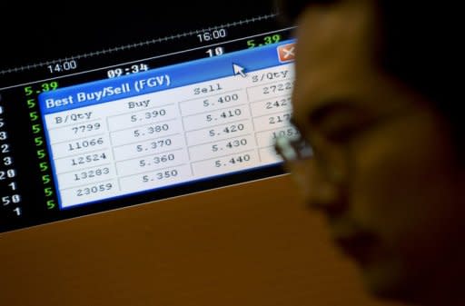 An employee watches trading of Felda Global shares on an electronic screen shortly after their stock market debut at Malaysia Stock Exchange in Kuala Lumpur, on June 28. Shares in Malaysian palm oil giant jumped 18.46% on its stock market debut defying global economic doldrums with the world's second-largest IPO this year after Facebook