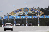 Park guests enter the Magic Kingdom during the reopening of Walt Disney World Saturday, July 11, 2020, in Lake Buena Vista, Fla. (AP Photo/John Raoux)