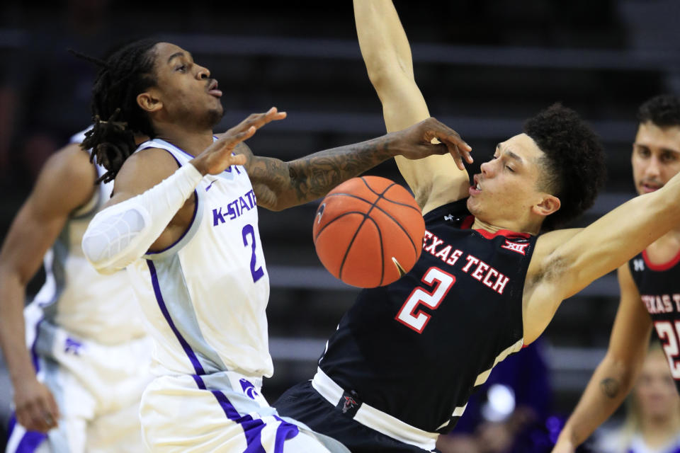 Kansas State guard Cartier Diarra, left, is fouled by Texas Tech guard Clarence Nadolny, right, during the first half of an NCAA college basketball game in Manhattan, Kan., Tuesday, Jan. 14, 2020. (AP Photo/Orlin Wagner)