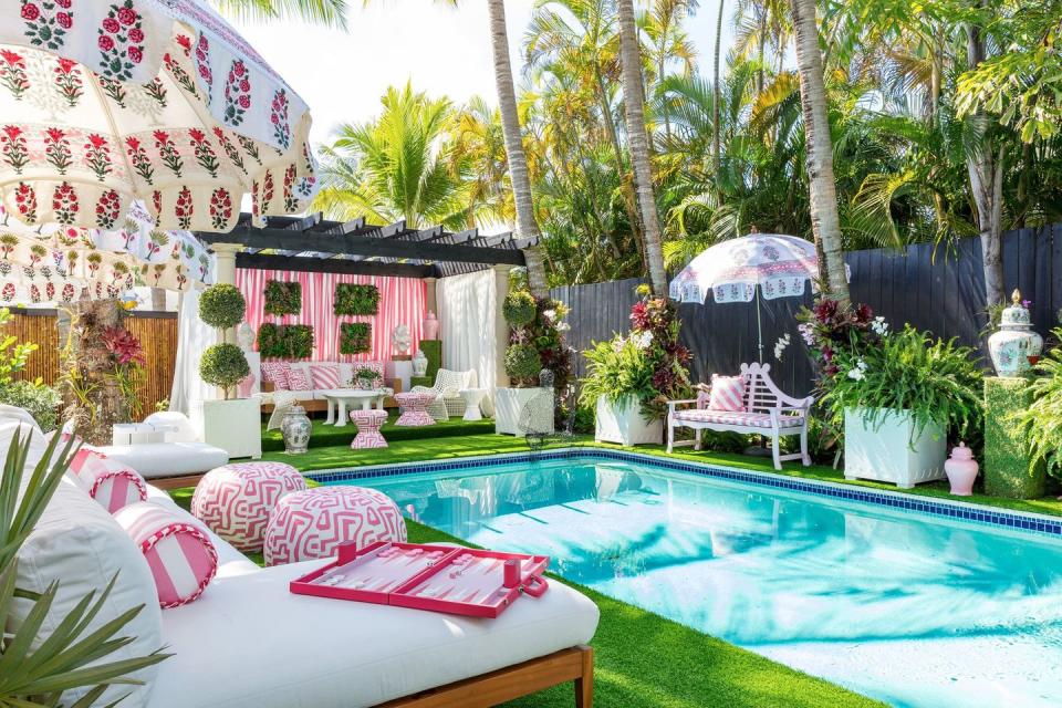 the janie molster&#x002013;designed poolside lounge in a variety of pink florals and stripes at the 2022 kips bay show house 2022 &#xa9; nickolas sargent