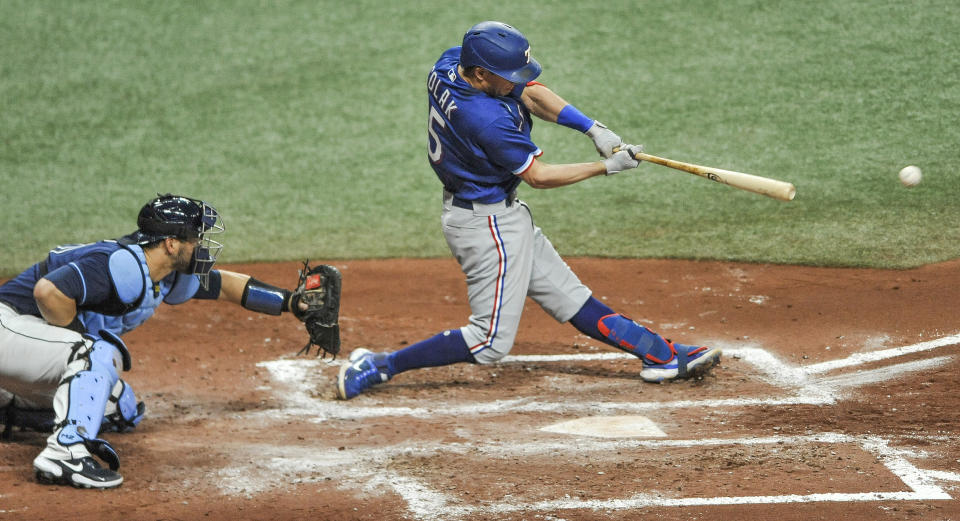 Tampa Bay Rays catcher Mike Zunino watches as Texas Rangers' Nick Solak, right, hits a three-run double during the fourth inning of a baseball game Tuesday, April 13, 2021, in St. Petersburg, Fla. (AP Photo/Steve Nesius)