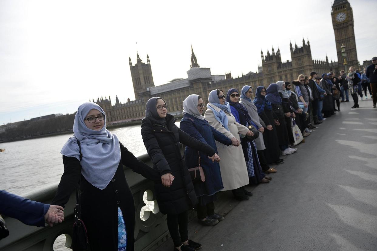 Tribute: Members of the 'Women's March' rally on Westminster Bridge: EPA