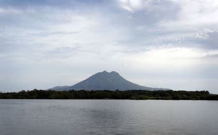 A mountain dominates the skyline above Ranai, the largest town in Indonesia's remote Natuna archipelago July 10, 2014. REUTERS/Tim Wimborne/Files