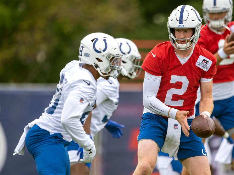 Colts QB Carson Wentz (2) gets ready to hand the ball off during a training camp session July 28.
