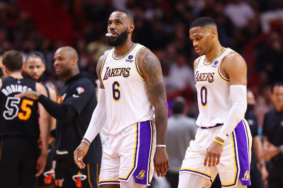 MIAMI, FLORIDA - JANUARY 23: LeBron James #6 and Russell Westbrook #0 of the Los Angeles Lakers react against the Miami Heat during the first half at FTX Arena on January 23, 2022 in Miami, Florida. NOTE TO USER: User expressly acknowledges and agrees that, by downloading and or using this photograph, User is consenting to the terms and conditions of the Getty Images License Agreement.  (Photo by Michael Reaves/Getty Images)