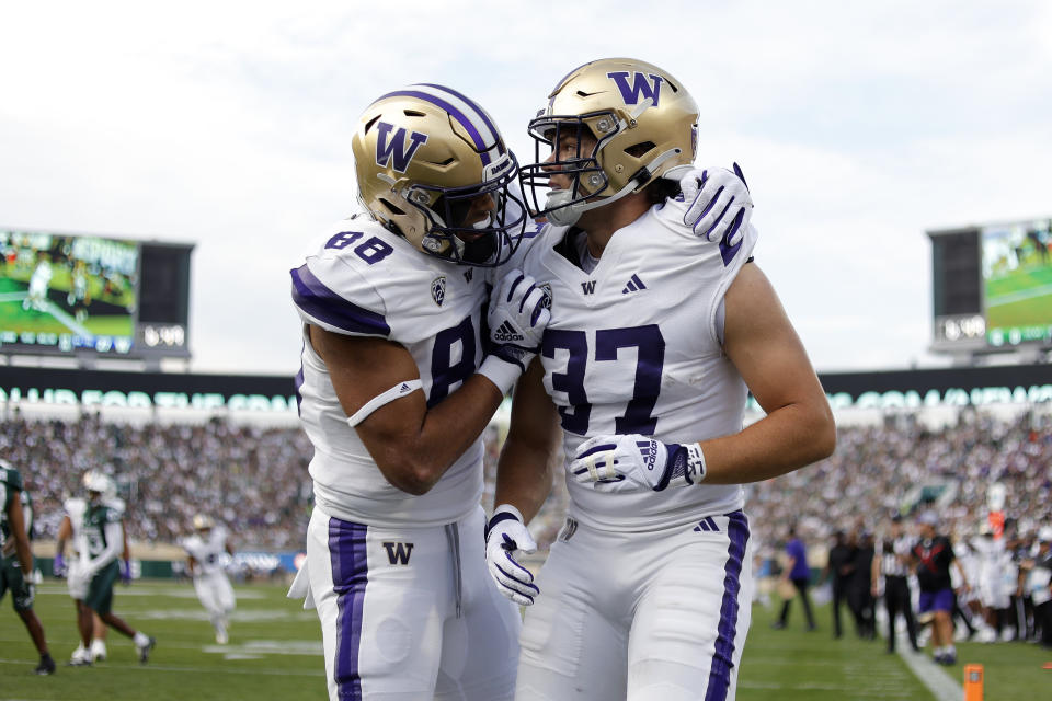 Washington's Jack Westover, right, and Quentin Moore celebrate Westover's touchdown against Michigan State during the first half of an NCAA college football game, Saturday, Sept. 16, 2023, in East Lansing, Mich. (AP Photo/Al Goldis)