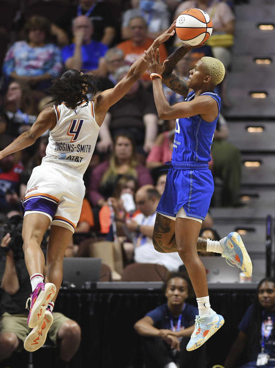 Phoenix Mercury guard Skylar Diggins-Smith (4) blocks a shot by Connecticut Sun guard Courtney Williams (10) during a WNBA basketball game Tuesday, Aug. 2, 2022, in Uncasville, Conn. (Sean D. Elliot/The Day via AP)