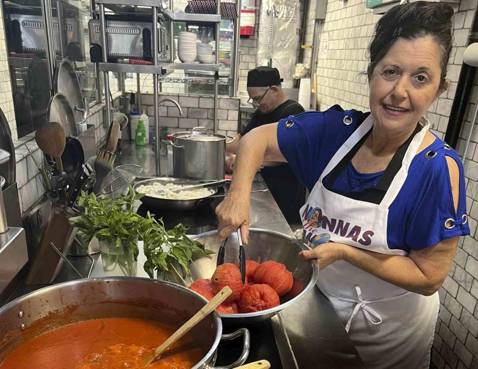 Enoteca Maria Nonna Christina from Italy cooks in the kitchen