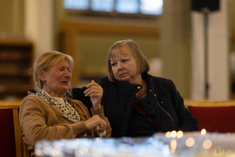 Constituent Ruth Verrinder (R) and former councillor and mayor Judith McMahon (L) gather their thoughts before lighting a candle at St Michael and All Angels Church, following the stabbing of UK Conservative MP Sir David Amess. Source: Getty