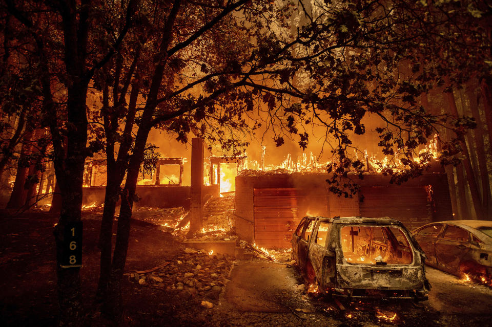 Flames consume a home as the Dixie Fire tears through the Indian Falls community in Plumas County, Calif., Saturday, July 24, 2021. The fire destroyed multiple residences in the area. (AP Photo/Noah Berger)