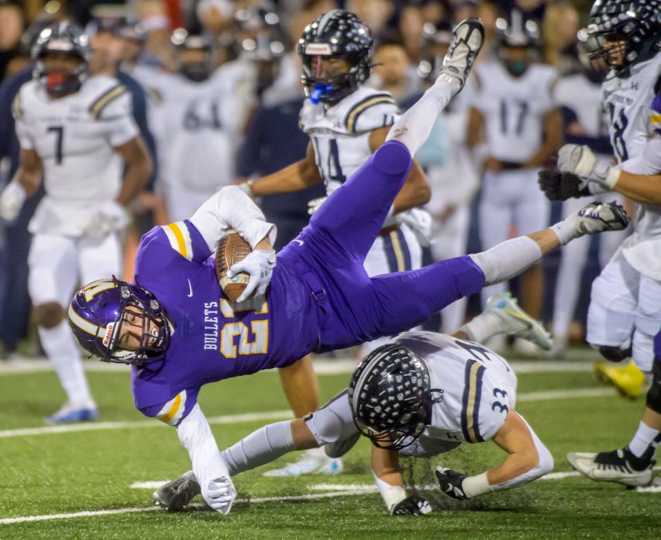 IC Catholic's Joey Gliatta (33) upends Williamsville's Jackson Workman in the first half of their Class 3A football state title game Friday, Nov. 25, 2022 in Champaign.