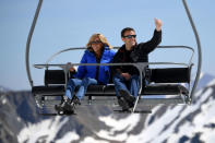 Emmanuel Macron, head of the political movement En Marche ! (Onwards !) and candidate for the 2017 presidential election, and his wife Brigitte Trogneux sit on a chairlift on their way to the mountain top for a lunch break during a campaign visit in Bagneres de Bigorre, in the Pyrenees mountain, France, April 12, 2017. REUTERS/Eric Feferberg/Pool