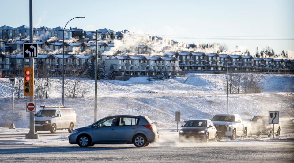 Traffic passes a steaming neighbourhood in Calgary on Saturday, Jan. 13, 2024. Weather warnings cover much of Canada this weekend, from arctic air flowing along British Columbia's coast to extreme cold in the Prairies and storms moving through southern Ontario, Quebec and the Maritimes.