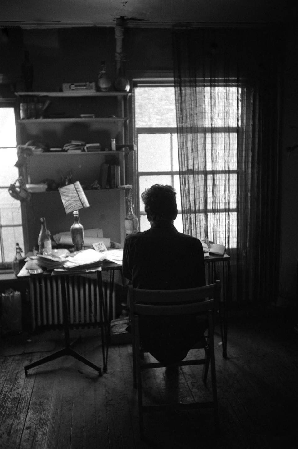 Bob Dylan silhouetted against window