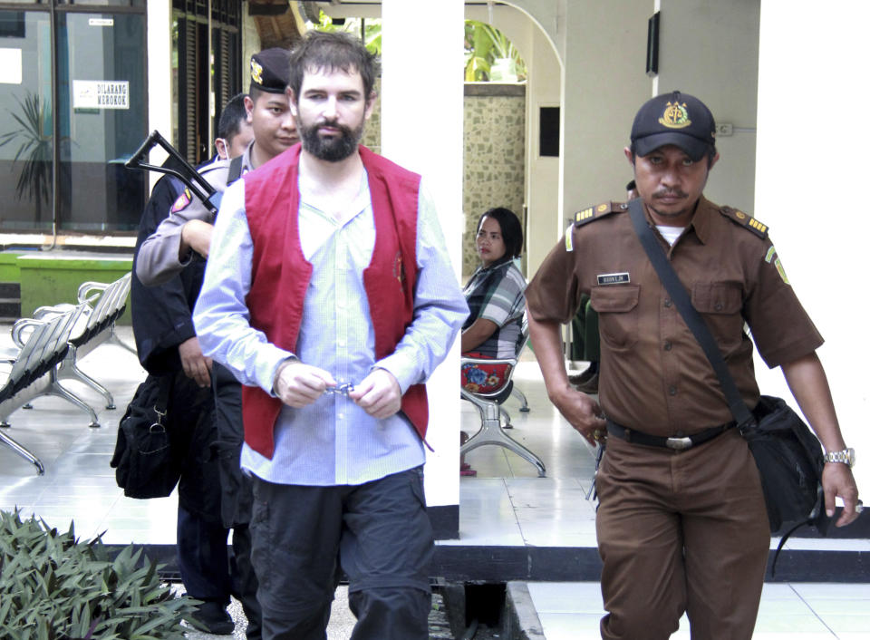 French national Felix Dorfin, left, is escorted by security personnel for his sentencing hearing at a district court in Mataram, Lombok Island, Indonesia, Monday, May 20, 2019. The court on Monday sentenced Dorfin to death for smuggling 3 kilograms (6.6 pounds) of drugs to the tourist island of Lombok, even though prosecutors had only sought a 20-year sentence. (AP Photo)