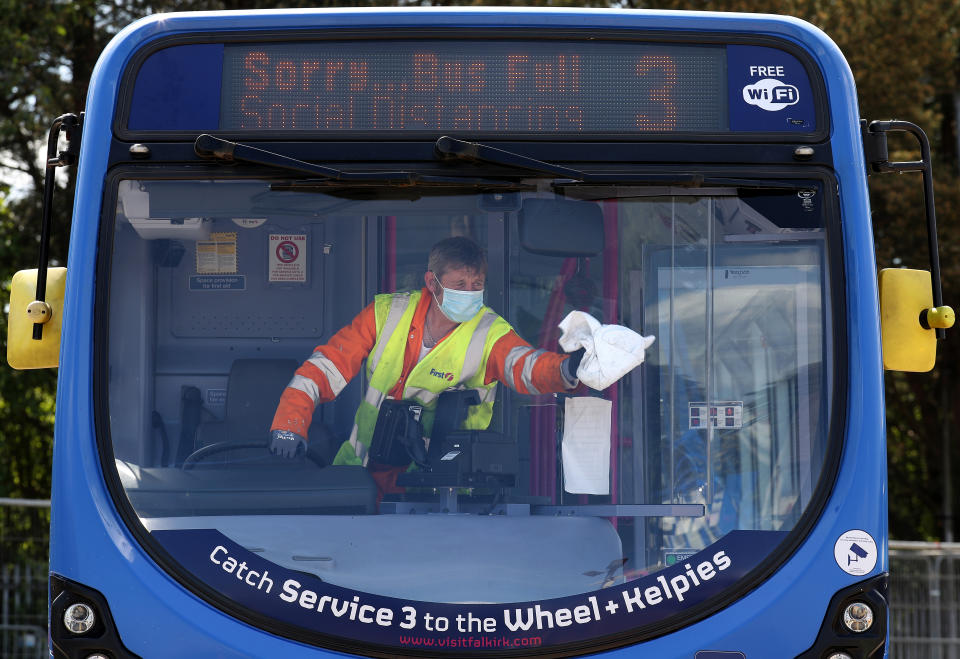 Cleaner James York from First Bus cleans a bus at their Larbert depot ahead of the bus returning to service. Due to social distancing measures only a certain amount of people will be able to travel on a particular bus at a certain time after the introduction of measures to bring the country out of lockdown. (Photo by Andrew Milligan/PA Images via Getty Images)