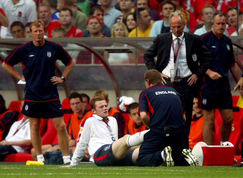 <p>England’s Wayne Rooney sits injured being watched over by coach Sven Goran Eriksson at Euro 2004. </p>