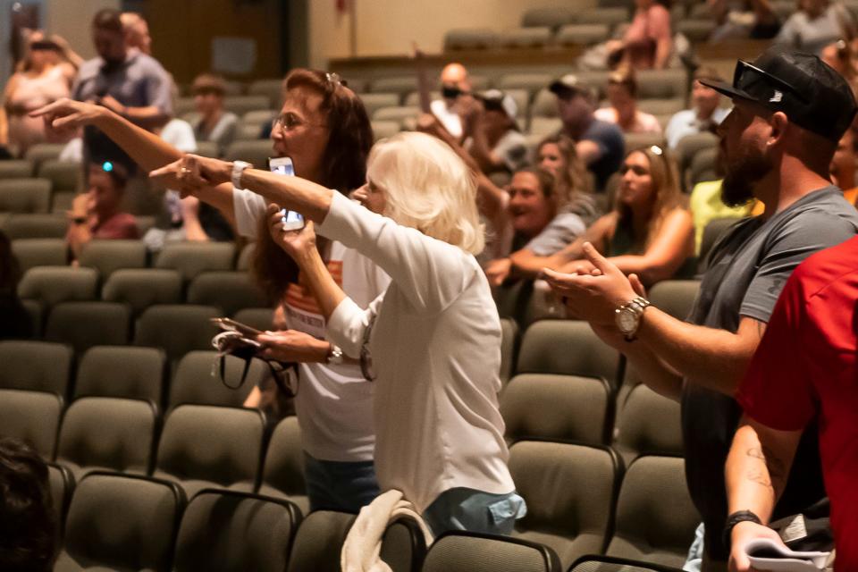 Attendees shout and point as several South Western School District school board members walk out of an emergency meeting at the high school in Penn Township on Wednesday, Sept. 8, 2021. The meeting was canceled after more than one hundred attendees refused to put on a face covering.