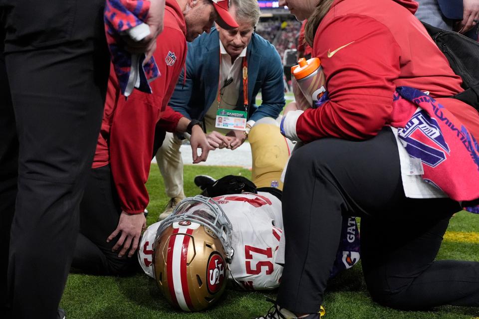 San Francisco 49ers linebacker Dre Greenlaw (57) is helped after an injury against the Kansas City Chiefs during the first half of Super Bowl 58.