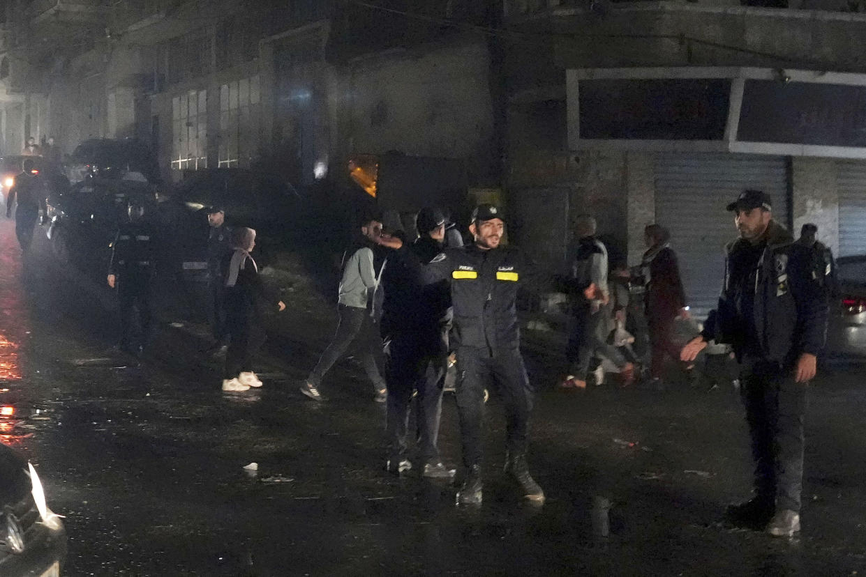 Hamas police officers secure the scene of burned apartment on the third floor of a three-story building in Jebaliya refugee camp, northern Gaza Strip, Thursday, Nov. 17, 2022. A fatal fire that broke out on Thursday evening in the northern Gaza Strip is one of the deadliest incidents in recent years outside the violence stemming from the Israeli-Palestinian conflict. (AP Photo/Adel Hana)