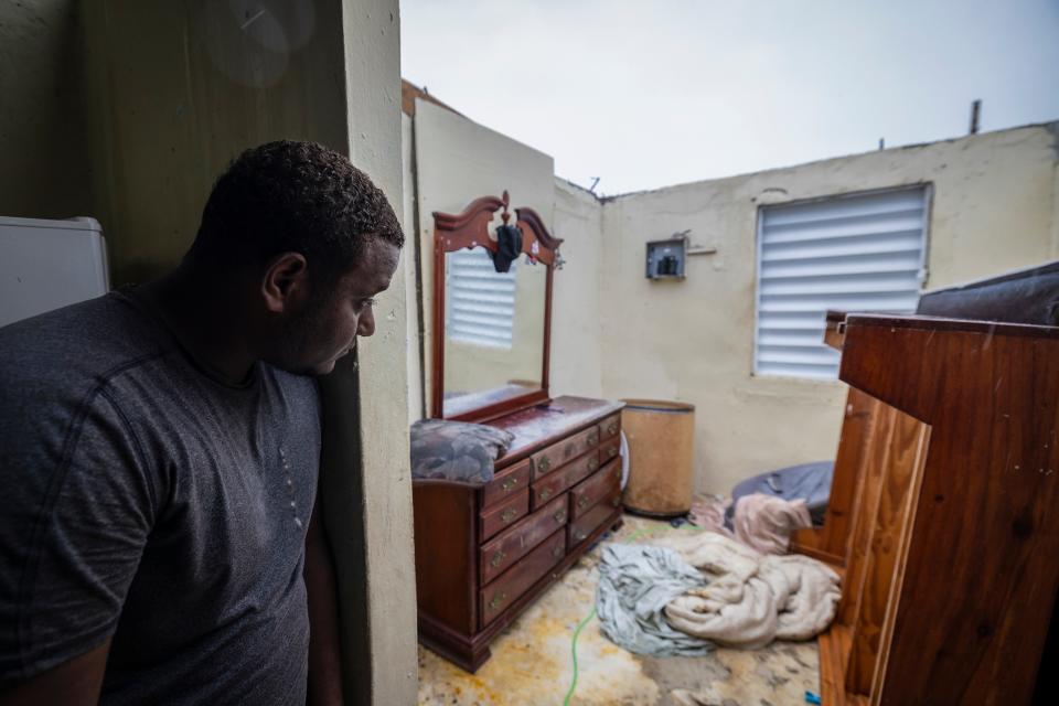 Nelson Cirino sees his bedroom after the winds of hurricane Fiona tore the roof off his house in Loiza, Puerto Rico, Sunday, Sept. 18, 2022. 