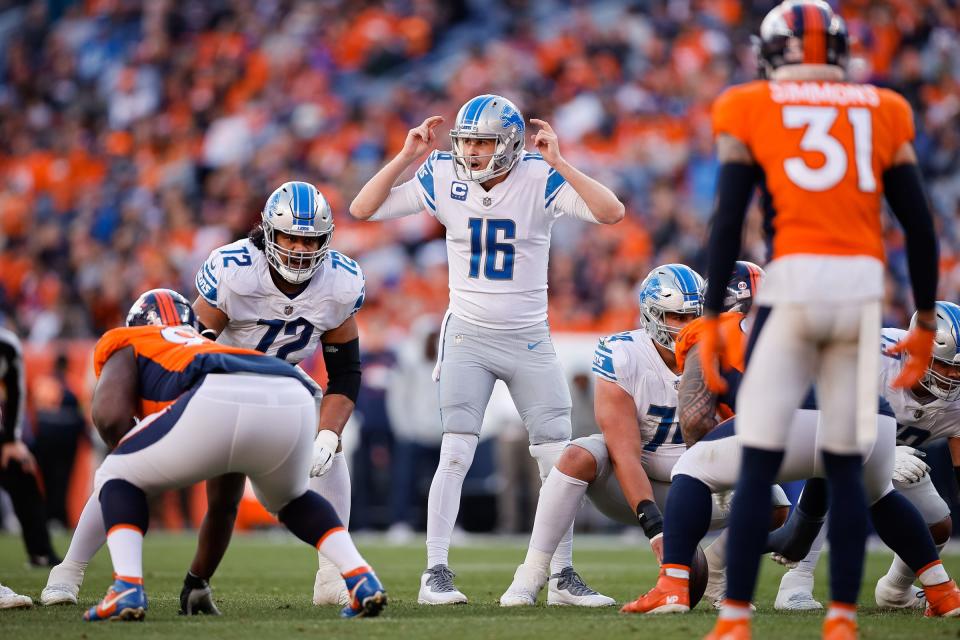 Detroit Lions quarterback Jared Goff (16) gestures at the line of scrimmage with guard Halapoulivaati Vaitai (72) as Denver Broncos safety Justin Simmons (31) looks on in the second quarter at Empower Field at Mile High on Dec. 12, 2021.