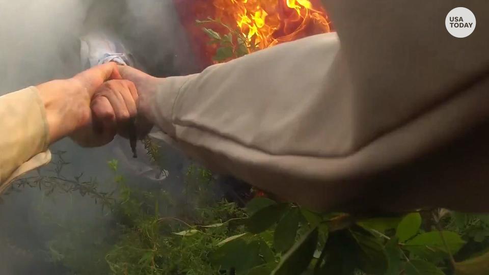 Bodycam footage captured Sgt. Ashleigh Taylor grabbing the hand of the driver stuck in a fiery car crash and pulling them to safety.