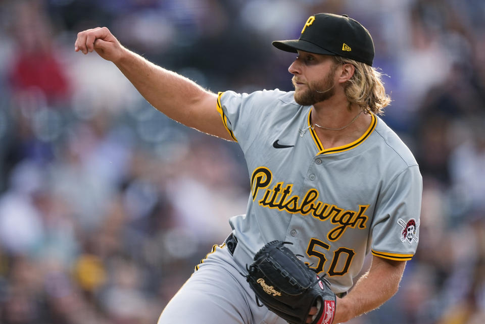 Pittsburgh Pirates starting pitcher Carmen Mlodzinski watches a throw to a Colorado Rockies batter during the first inning of a baseball game Friday, June 14, 2024, in Denver. (AP Photo/David Zalubowski)