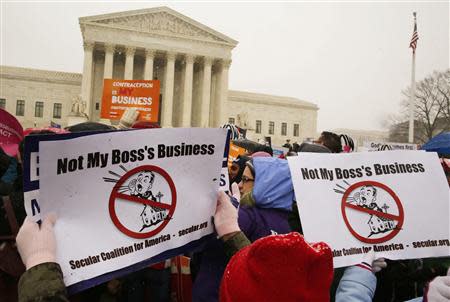 Protesters rally at the steps of the Supreme Court as arguments begin today to challenge the Affordable Care Act's requirement that employers provide coverage for contraception as part of an employee's health care, in Washington March 25, 2014. REUTERS/Larry Downing