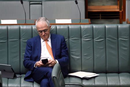 Australian Prime Minister Malcolm Turnbull uses his phone in the House of Representatives at Parliament House in Canberra, September 14, 2016. AAP/Lukas Coch/via REUTERS