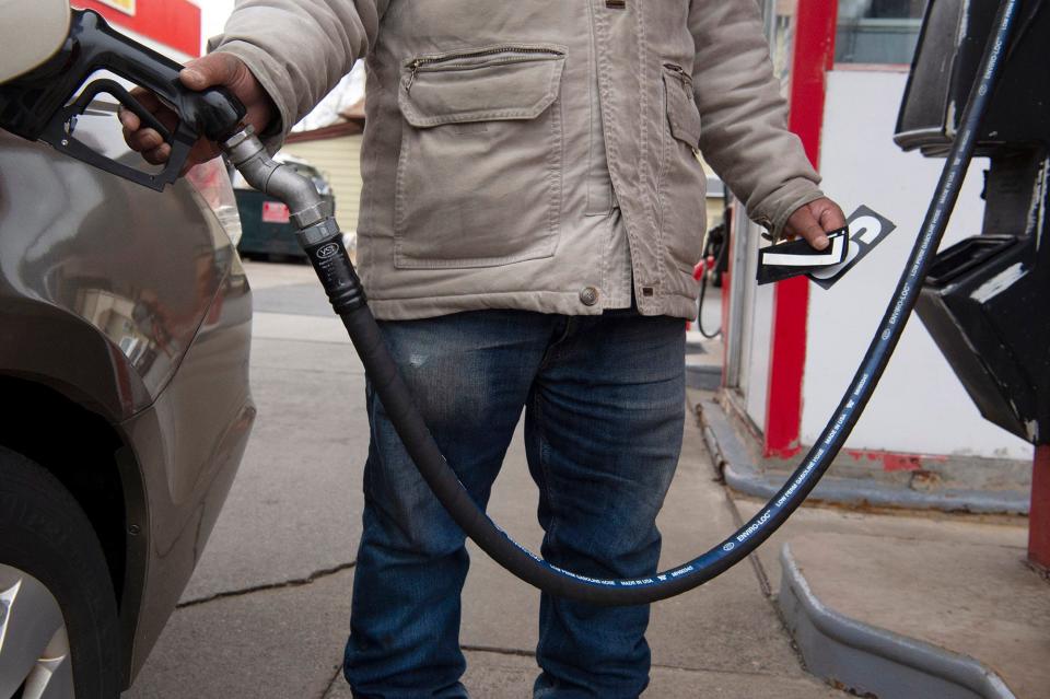 Gas station attendant Inderjeet Singh holds magnetic numbers as he prepares to change the price of gas at a Delta station in Fair Lawn. Thursday Feb. 24, 2022.