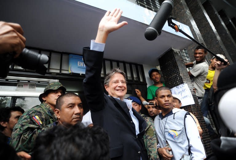 Ecuadorian opposition candidate Guillermo Lasso waves after casting his vote during general elections in Guayaquil on February 17, 2013. Lasso, who had around 24% of the vote in the preliminary tally, conceded defeat shortly after the results were announced