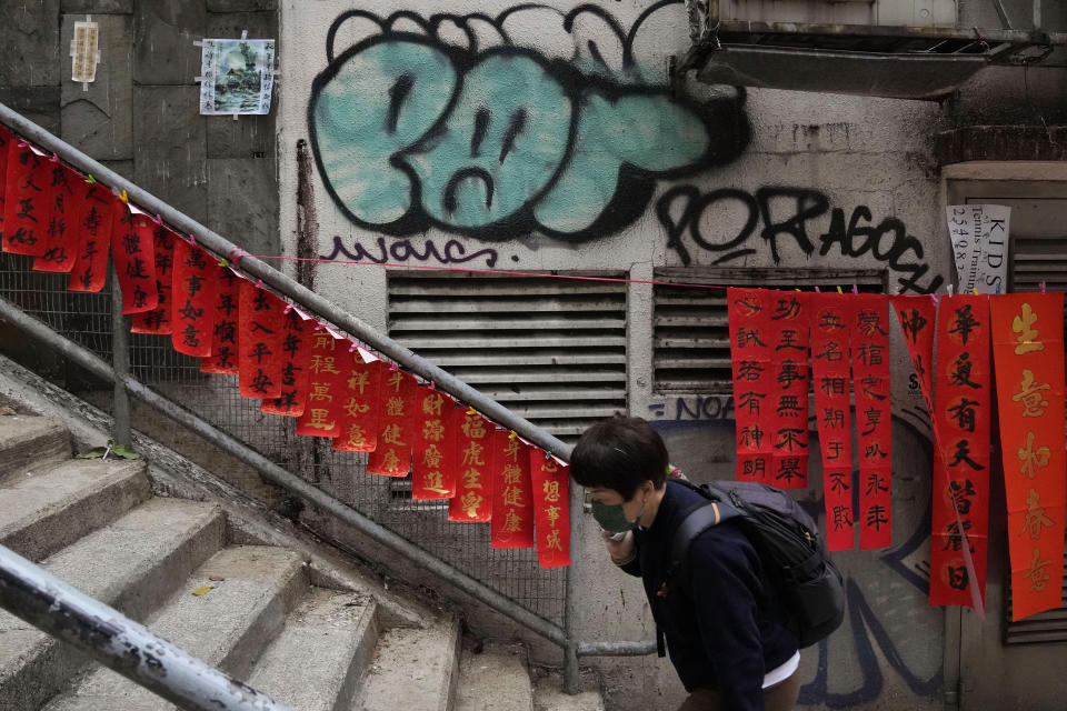 Traditional decorations with Chinese calligraphy, "Fai Chun," created by calligraphy artist Raymond Siu, are displayed for sale in Hong Kong on Jan. 26, 2022. In the runup to the Lunar New Year, calligraphers set up on the streets of Hong Kong to write ink-brush phrases on traditional red paper banners for homes and offices. (AP Photo/Kin Cheung)