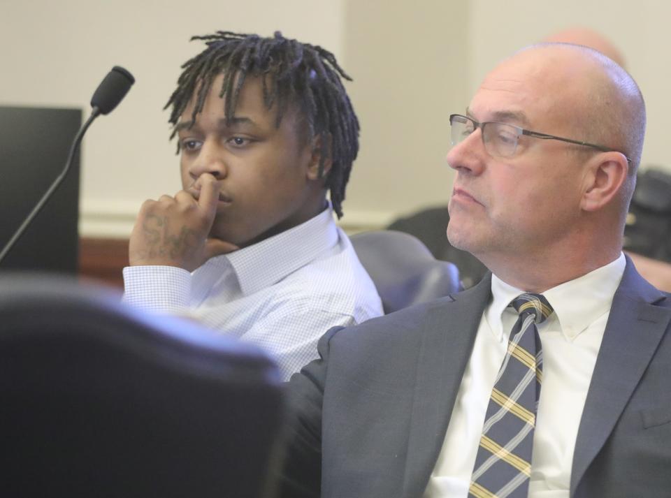 Cameron Jones, left, and defense attorney Erik Jones listen to Judge Joy Malek Oldfield give jury instructions Friday in Akron.